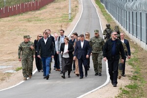 Wizyta Ministrów Spraw Wewnętrznych Polski i Irlandii na granicy polsko-białoruskiej grupa osób idzie przy granicy