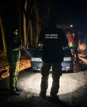 Działania Straży nocą Oświetlony latarką samochód