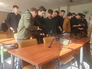 Uczniowie oglądają i przymierzają sprzęt służbowy SG 